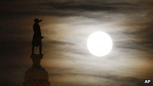 A bronze statue of George Washington by the light of a full moon in Trenton, New Jersey, on 29 November 2012