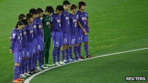 Players of the Japanese team Sanfrecce Hiroshima observe a minute's silence at football's Club World Cup on Thursday