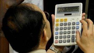 Man using a calculator