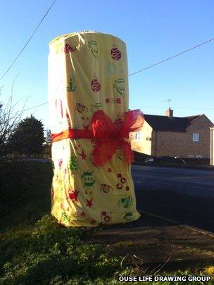 Post box wrapped up as a Christmas present in Prickwillow, Cambs