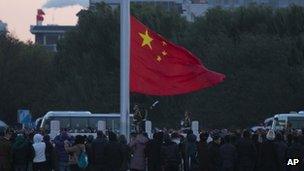 People raise Chinese flag in Beijing, China November 2012