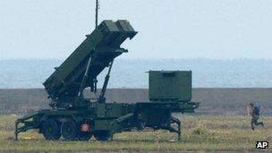 A Japanese soldier runs toward a Patriot Advanced Capability-3 interceptor on southern Japanese island of Ishigaki on 12 December 2012