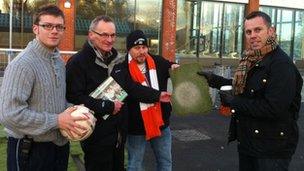 Fans with the penalty spot from Luton Town's artificial pitch