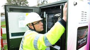 BT Engineer working on a green street cabinet