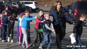 The police lead children away from Sandy Hook Elementary School