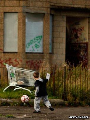 Child playing near derelict housing