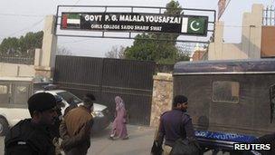 Police officers stand guard after students protested against the naming of Saidu Sharif College after schoolgirl Malala Yousafzai, in Swat December 12, 2012