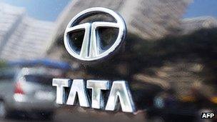 The Tata logo shines on the boot of a car reflecting high-rise buildings of south Mumbai's business district, 31 January 2007.