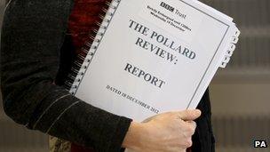 A journalist holds a copy of the Pollard Review, on the day it was published