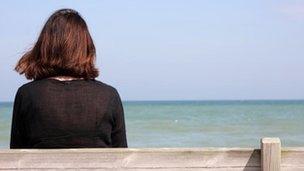 A woman sitting alone