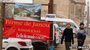 A sign, reading "The end of the world, is here", in Bugarach, France