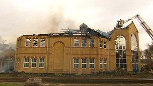 The new school building still smoking after the fire