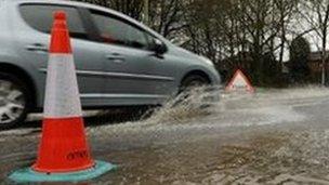 Car drives through flood