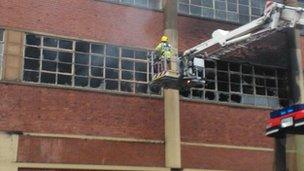 Firefighters tackle the remaining fire pockets at the Twyford building