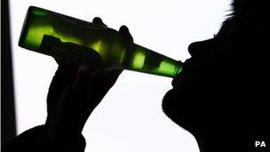 File photo of a person drinking a bottle of beer