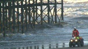 Coastguard searching shoreline beneath Blackpool's South Pier