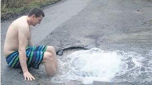 Liam Keane dips his feet in the pothole