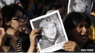 Protesters hold up posters of Matias Catrileo at a rally in Santiago on 4 January 2012