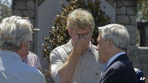 President Sebastian Pinera (r) speaks to friends and relatives of the Luchsingers