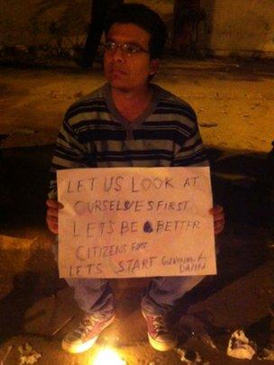 man holds placard