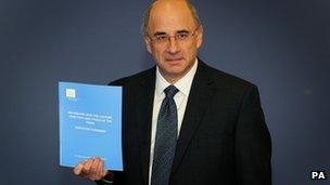 Lord Leveson with his report