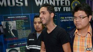 Hamza Bendelladj is lead away by Thai police