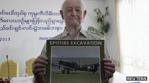 Stanley Coombe poses with picture of Spitfire fighter plane. 9 Jan 2013