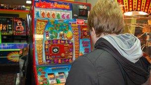 Person playing fruit machine