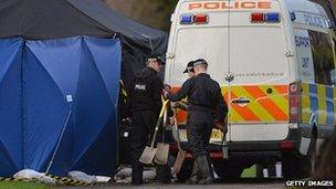 Forensic officers at the grave