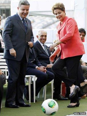 Dilma Rousseff kicks a ball as she opens the Minerao stadium in Belo Horizonte on 21 December