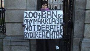 Jackie Mullins holds a placard outside the Irish houses of parliament