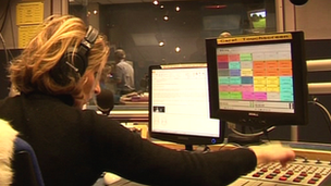 A radio presenter at her console