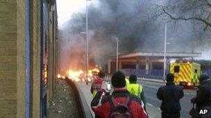 Pedestrians look at the helicopter wreckage.