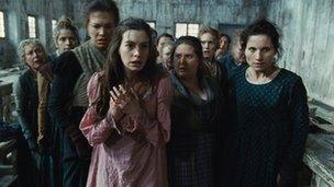 Anne Hathaway (centre) with others in a scene from Les Miserables