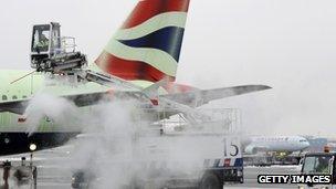 A BA flight being de-iced at Heathrow