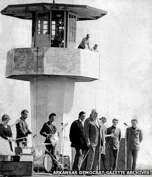 Governor Rockefeller talking with the crowd at Cummins prison with Johnny Cash and his band behind, April 1969