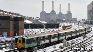 Trains on snowy tracks near London Victoria Station and Battersea Power Station