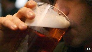 Man drinking pint of beer (file)