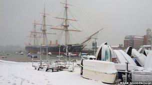 Snowy scene at Portsmouth Dockyard with HMS Warrior in the background