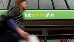 Woman walks past job centre