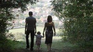 Family walking through trees