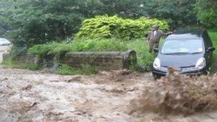 Flood water running down a road in Hebden Bridge