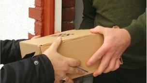 Closed up shot of parcel being handed over on a doorstep