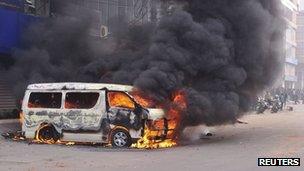 A minibus is set ablaze during a clash between Islamist activists and police in Dhaka January 28, 2013.