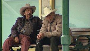 Two men sit on a bench in Laredo, Texas