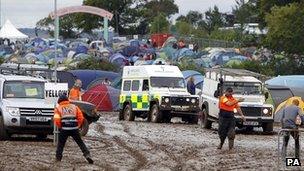 An ambulance is towed off the site at the Isle of Wight festival, after heavy rains turned the site into a mudbath causing traffic chaos.