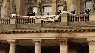 Protestors on the council house balcony