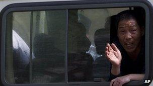 File image of a petitioner trying to draw public attention to his case yelling out from a police van in Beijing on 8 May 2012