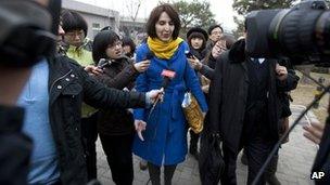 Kim Lee walks into a court for her divorce trial in Beijing, China, on 22 March 2012