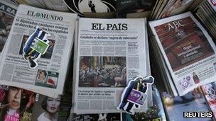 Copies of El Pais (centre) lie between other papers at a kiosk in Madrid, 24 January